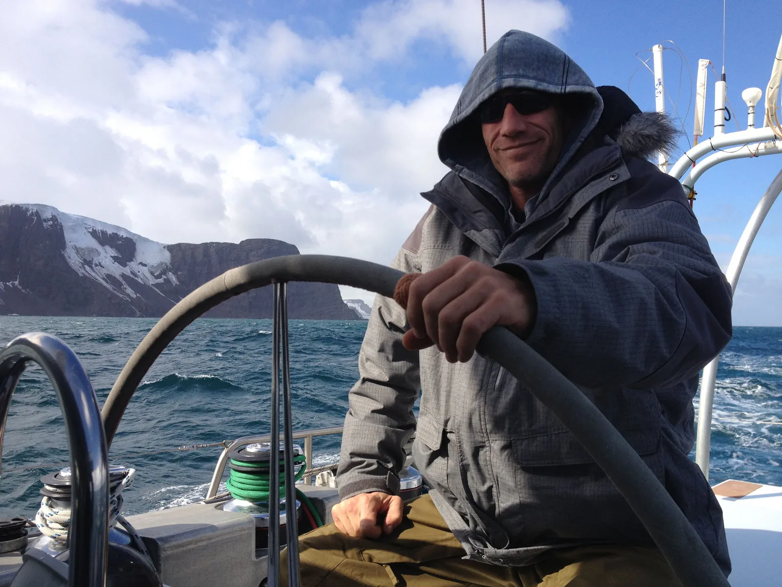 Kenneth Corben steering boat in Antarctica